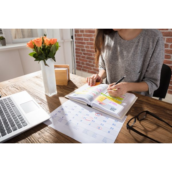 Close Up to a Working Woman with her Laptop and Flowers