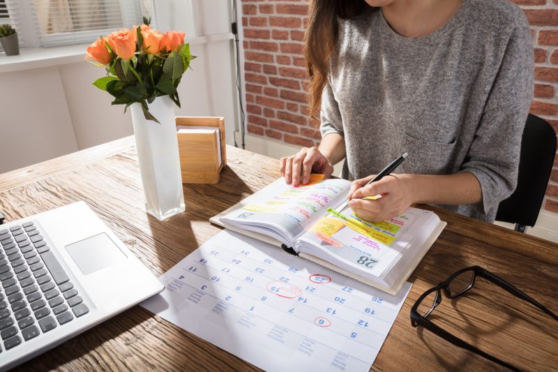 Close Up to a Working Woman with her Laptop and Flowers