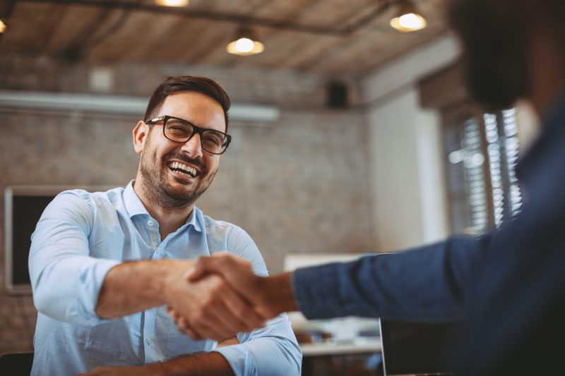 Happy Man Shaking Hands with Someone