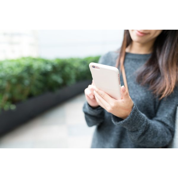 Woman Holding a Pink iPhone