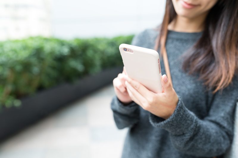 Woman Holding a Pink iPhone