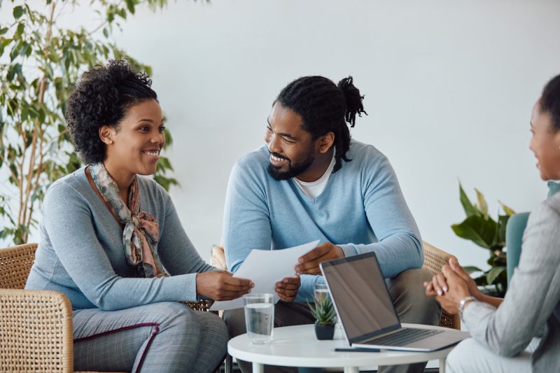 Happy Home Owners Talking with Agent