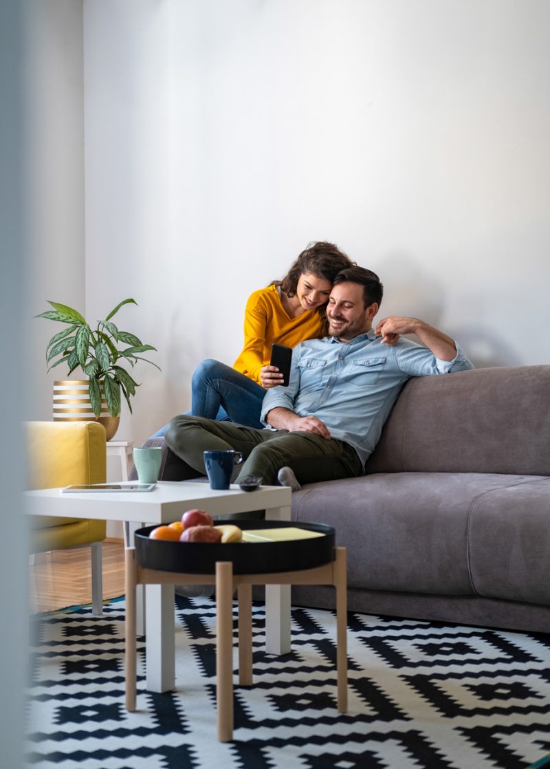 Couple Watching Cellphone in the Livingroom