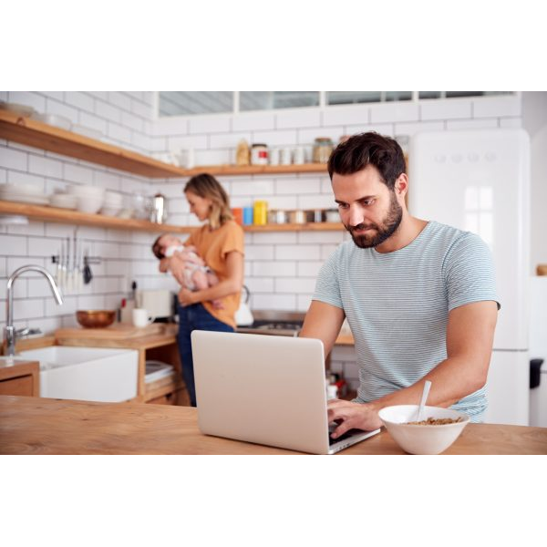 Couple with Baby in a Kitchen and Laptop