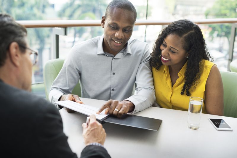 Happy Home Owners Reviewing a Contract