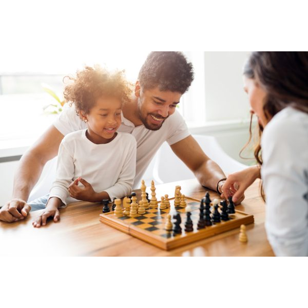 Father, Daughter and Mother Playing Chess