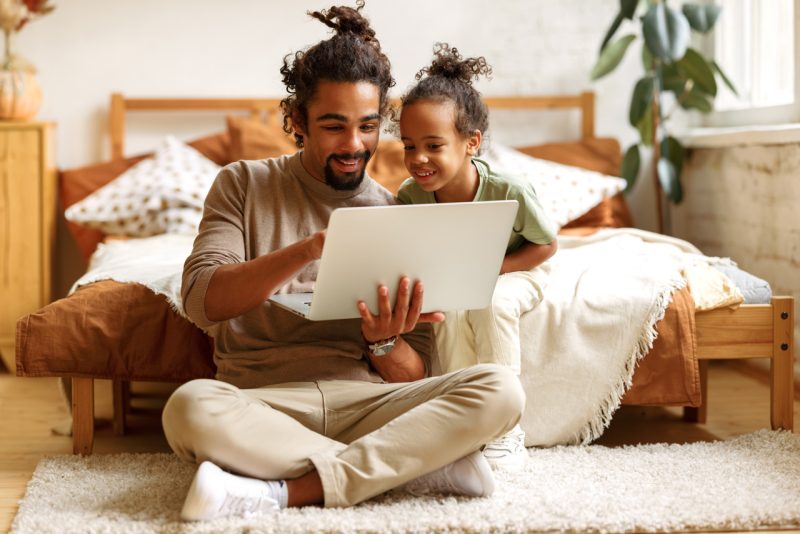 Young Father and Daughter with Laptop