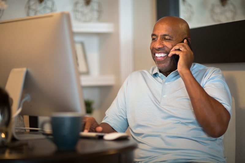 Happy Man on the Phone with Computer