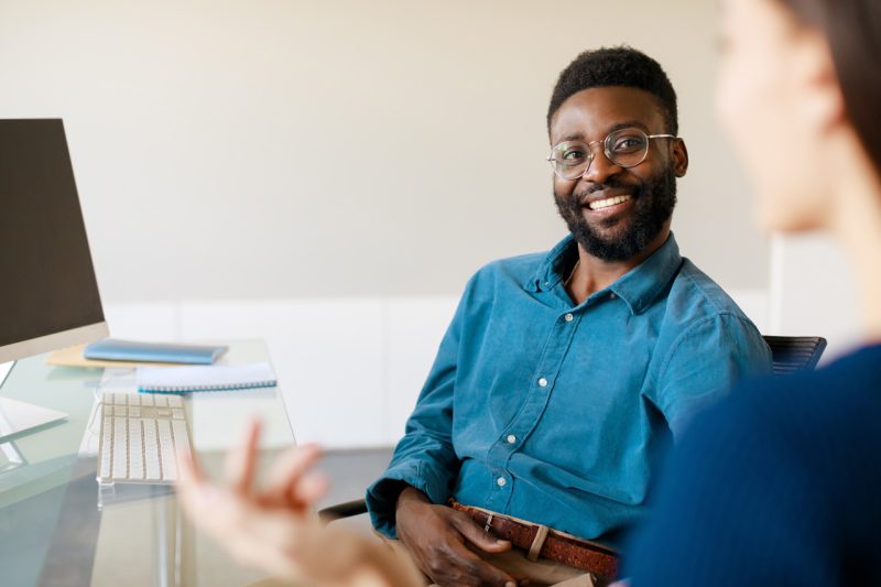 Man Smiling Working with Computer