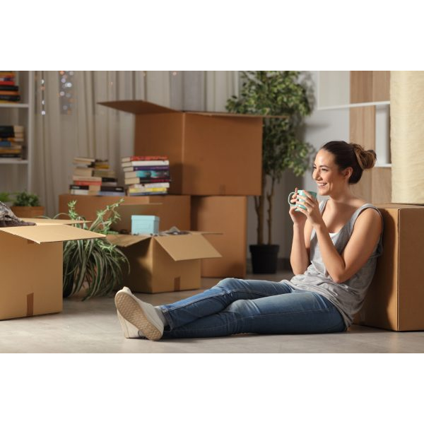 Happy Woman Moving In with Boxes