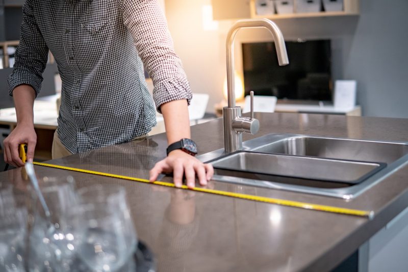 Man Measuring the Kitchen