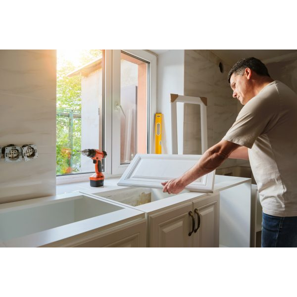 Man fixing a cabinet