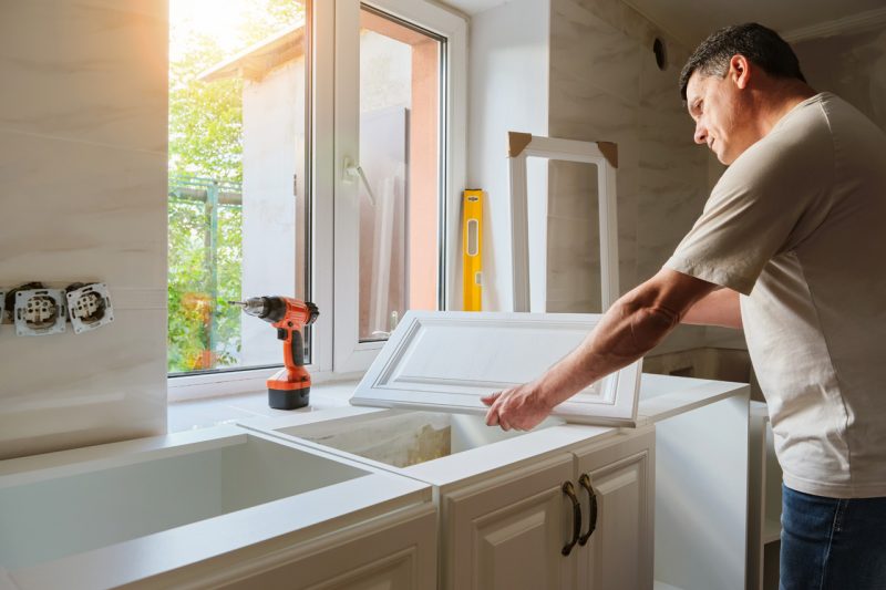 Man fixing a cabinet