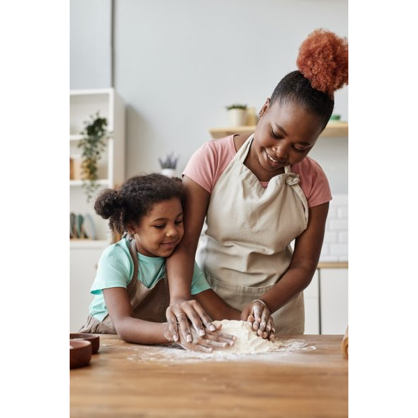 Young Mother and Daughter Baking a Cake