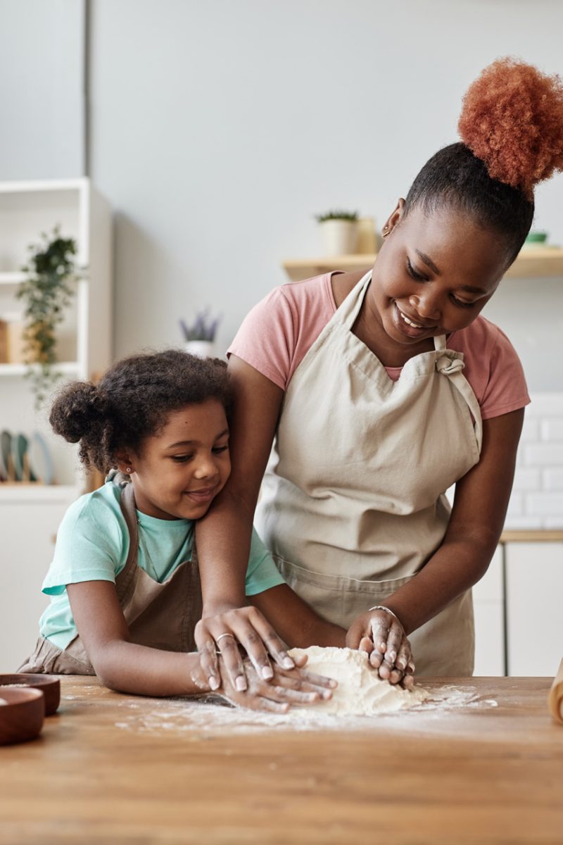 Young Mother and Daughter Baking a Cake