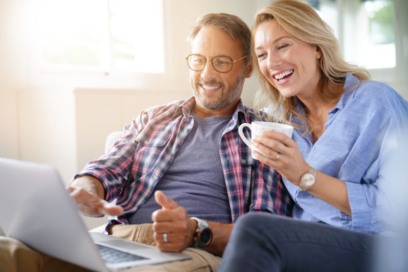 Older Couple Smiling at a Tablet