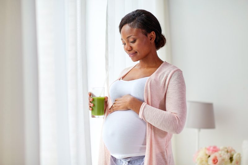 Pregnant Young Woman Drinking Green Juice