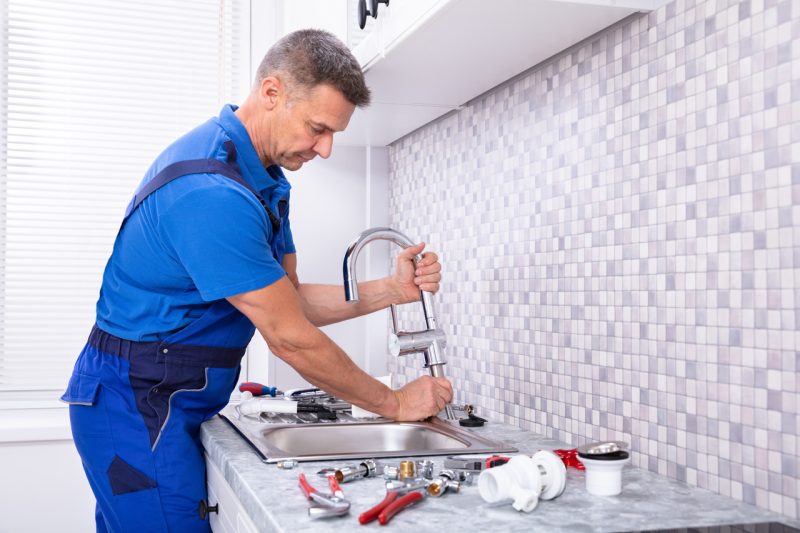 Man Repairing the Sink