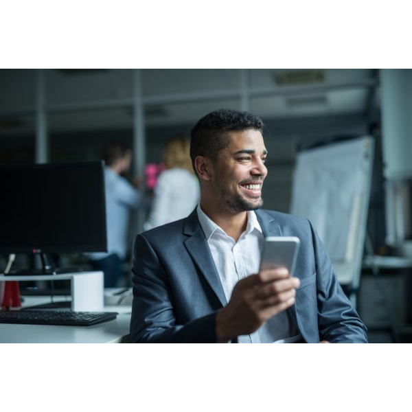 Man Working Smiling Sending a Text