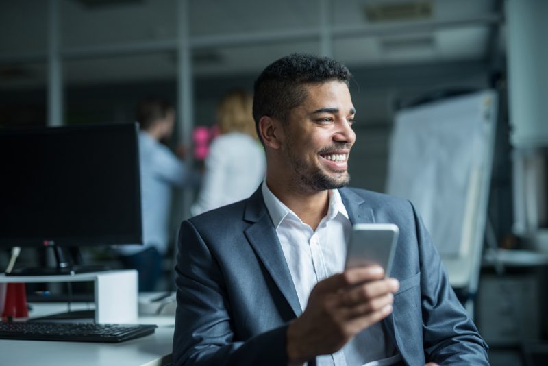 Man Working Smiling Sending a Text