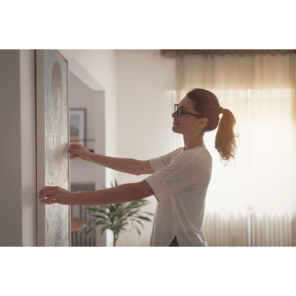 Woman Hanging a Frame