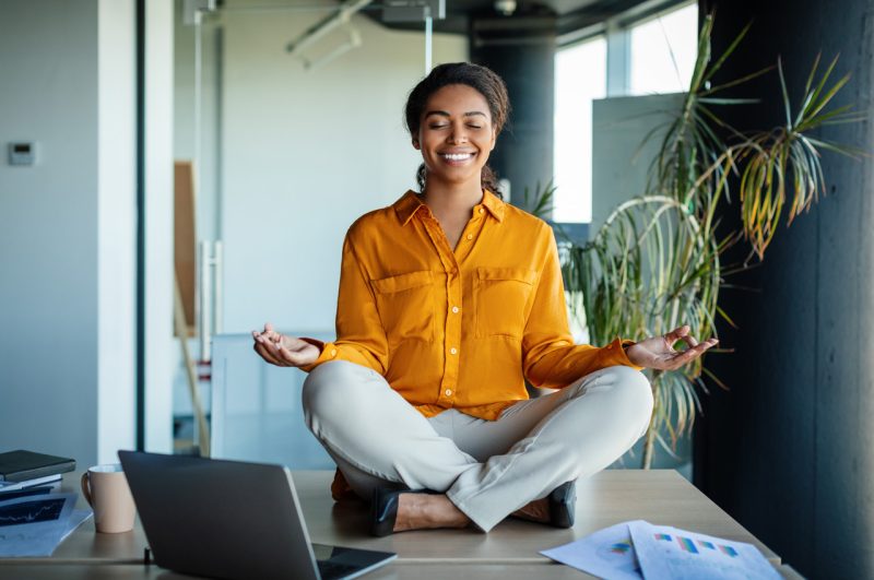 Young Woman Meditating in Her Office