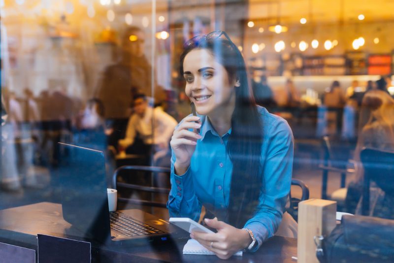 Woman Working inside a Coffee Place