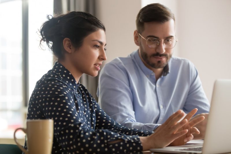 Woman and Man Working with Laptop