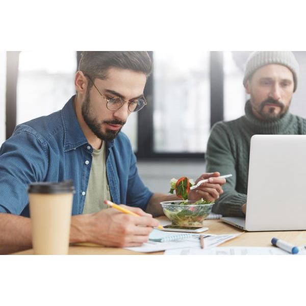 Young Man Having Lunch and Working