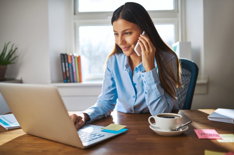 Woman Making a Call while Working in Her Office